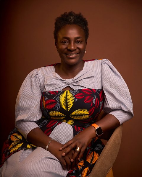 Woman in a red and yellow print dress